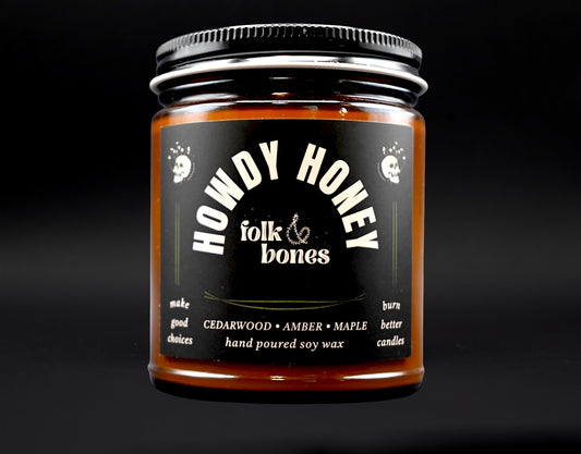 Folk and Bones Howdy Honey soy candle in an 8 oz container with a rustic label and warm, inviting appearance.