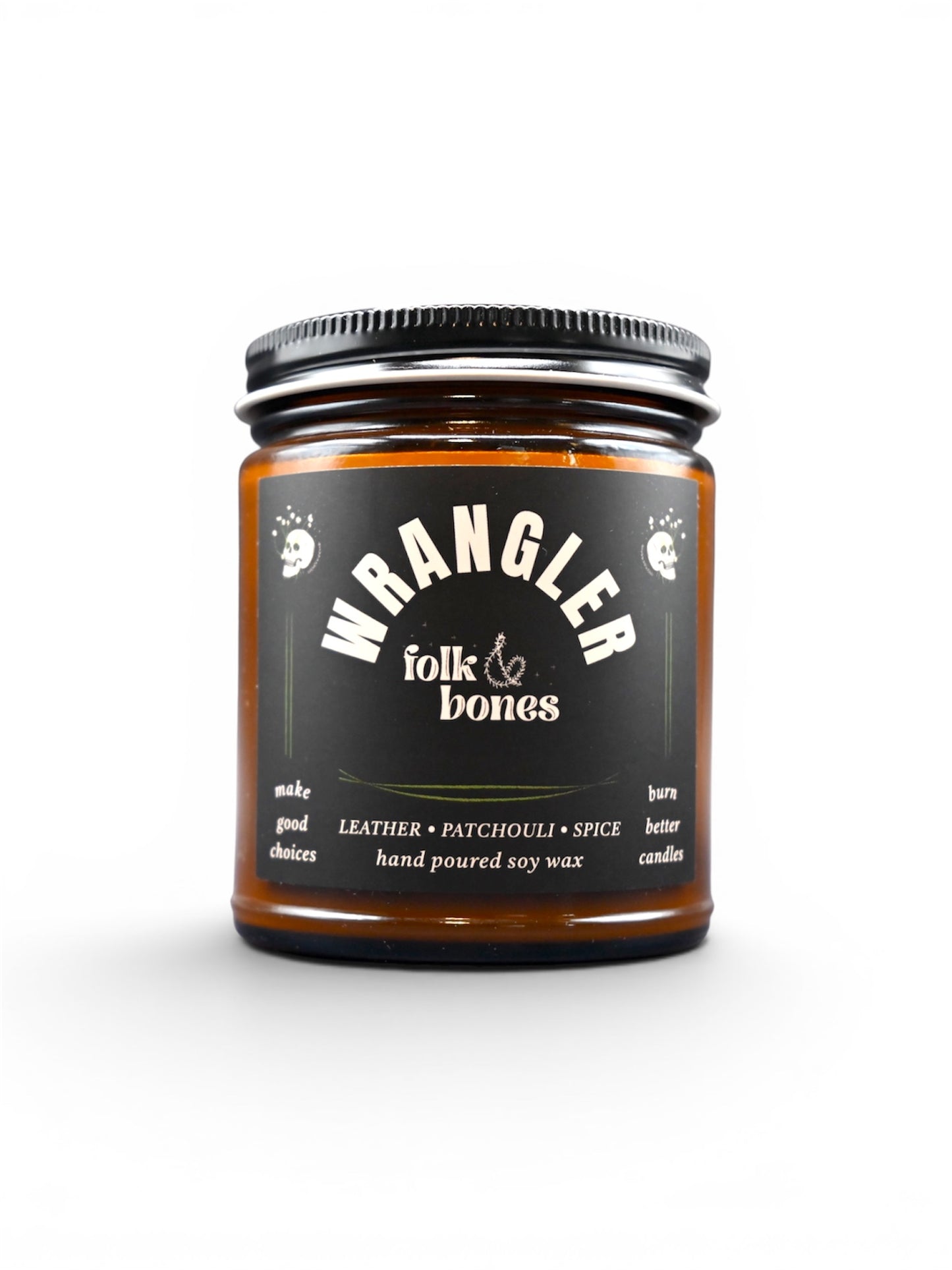 Wrangler Folk and Bones 8 oz soy candle in a glass jar with a wooden lid, featuring a rustic label and a lit wick.