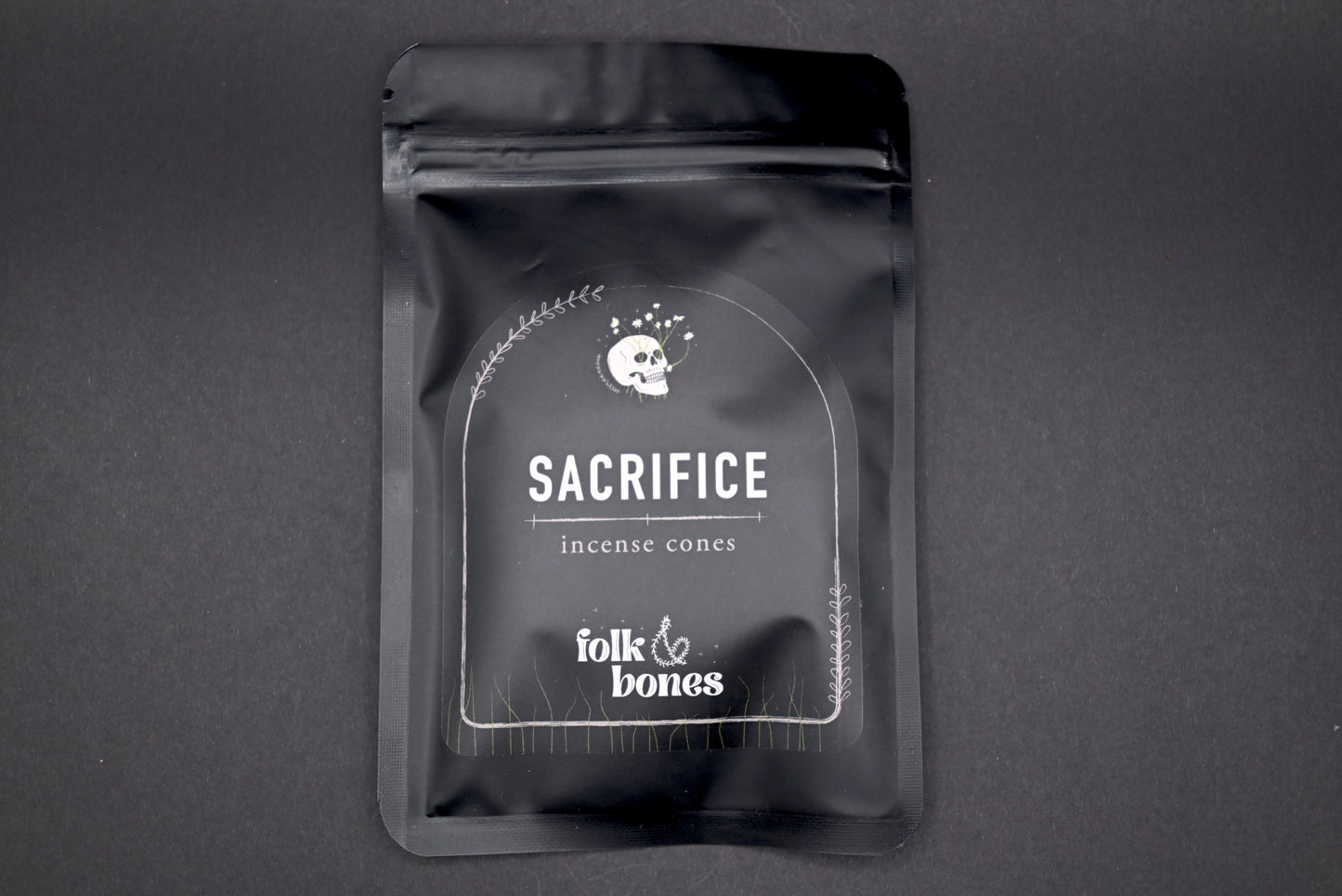 Folk and Bones Sacrifice incense cones set with package of aromatic candles, used for spiritual or decorative purposes.