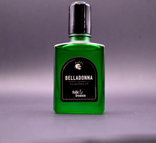 Folk and Bones Belladonna 1 oz perfume oil candle with dark wax and elegant label, ready for aromatic use.