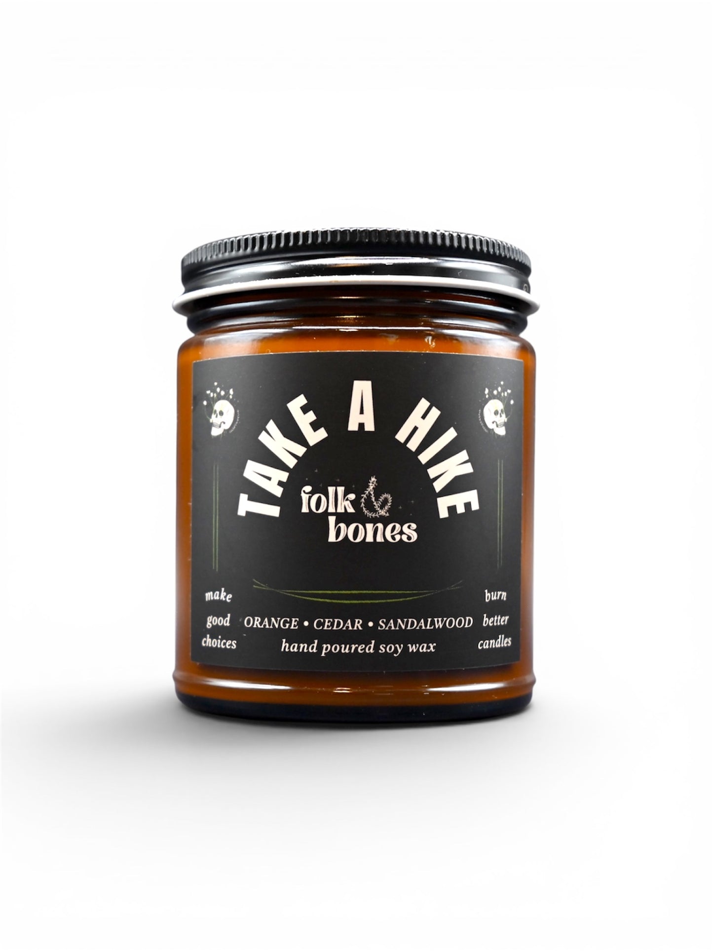 Folk and Bones Take a Hike 8 oz soy candle in a glass jar with a wooden lid, featuring a nature-inspired label and a warm, inviting glow.