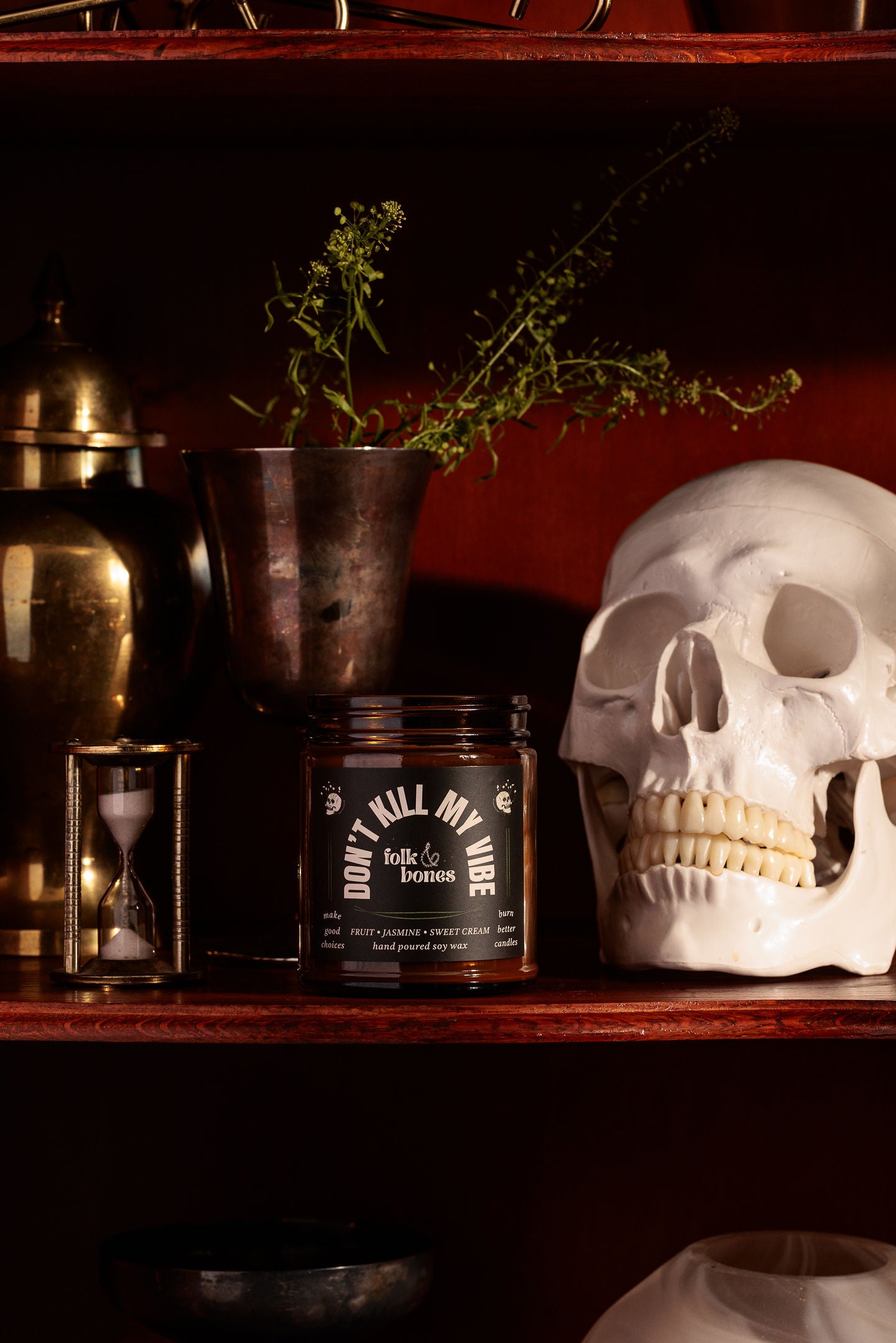 Don't Kill My Vibe lifestyle photo with candle on a shelf by a skull