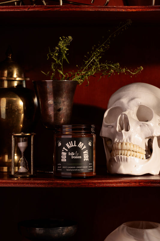 Don't Kill My Vibe lifestyle photo with candle on a shelf by a skull
