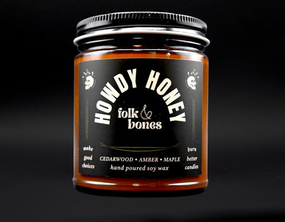 Folk and Bones Howdy Honey soy candle in an 8 oz container with a rustic label and warm, inviting appearance.