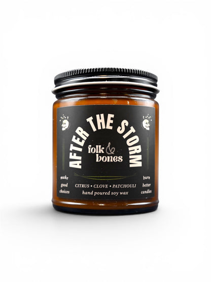 Folk and Bones After the Storm 8 oz soy candle in a glass jar with a natural, rustic label and a wick ready for lighting.