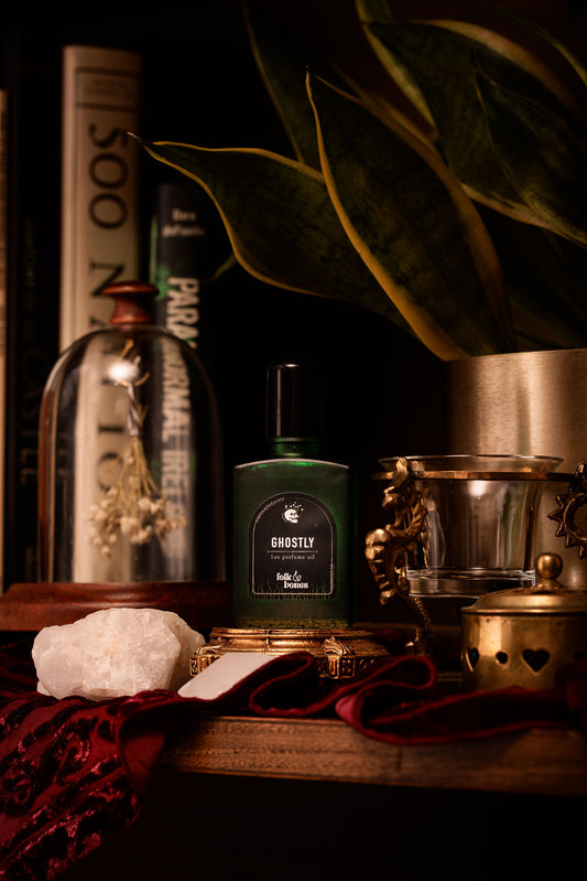 Folk and Bones Ghostly 1 oz perfume oil candle with dark, mysterious design and subtle ghostly branding visible.