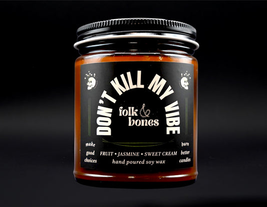 Folk and Bones Don't Kill My Vibe 8 oz soy candle in a glass jar with a natural wick, ready to add ambiance to any space.
