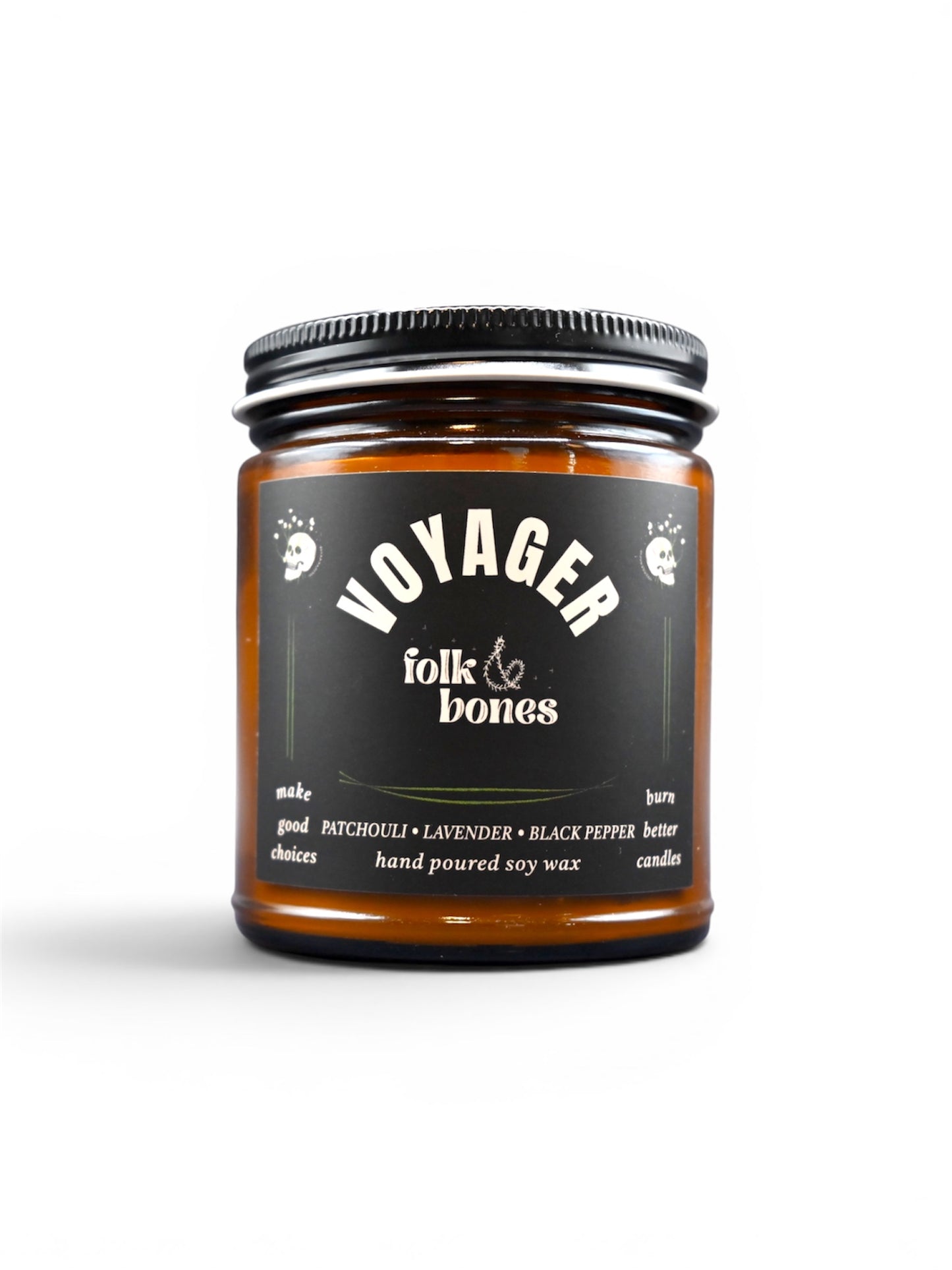Folk and Bones Voyager 8 oz soy candle in a clear glass jar with a white wick and minimalistic label, ready to add ambiance.