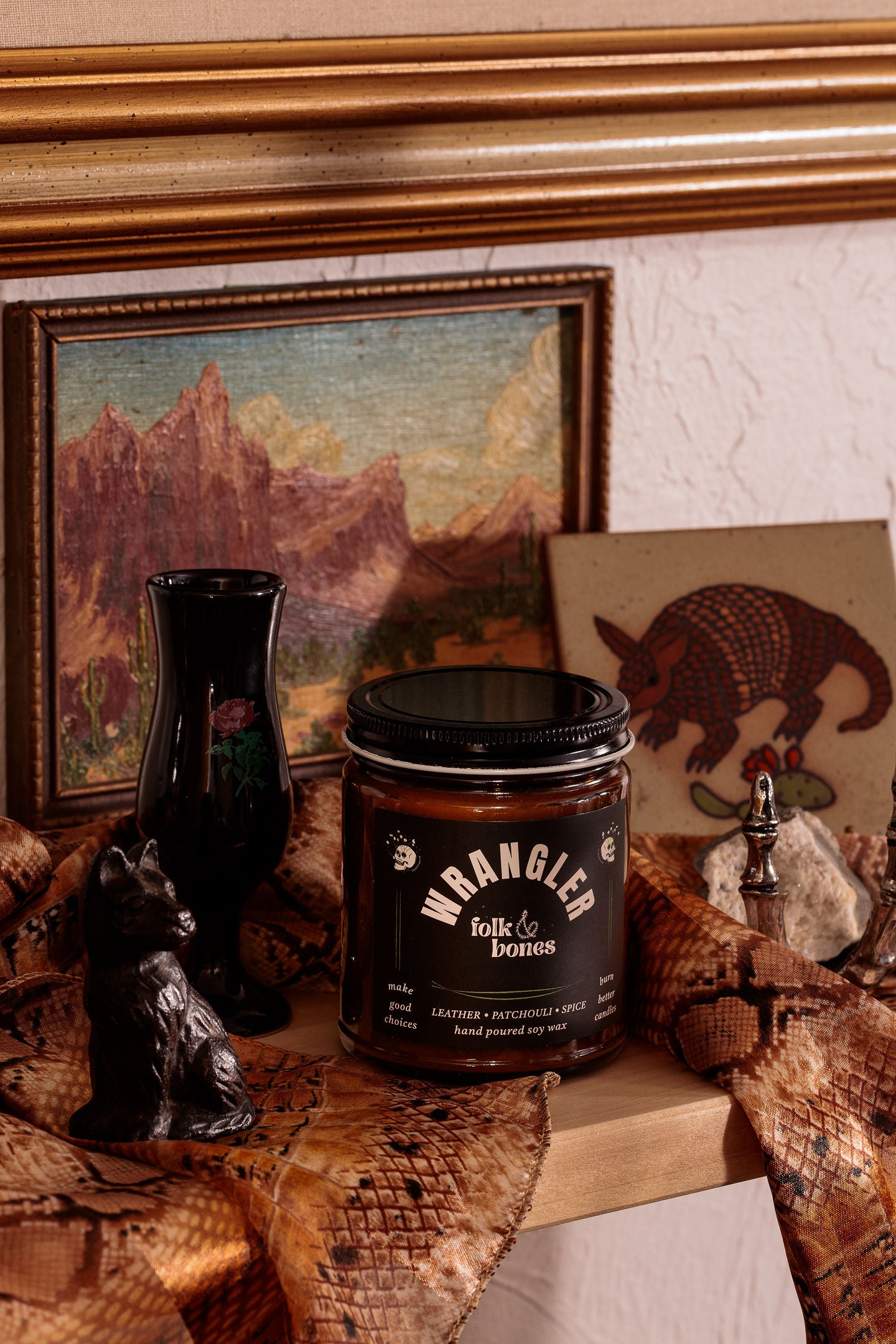 Wrangler Folk and Bones 8 oz soy candle in a glass jar with a natural wick, perfect for home decor and ambient lighting.