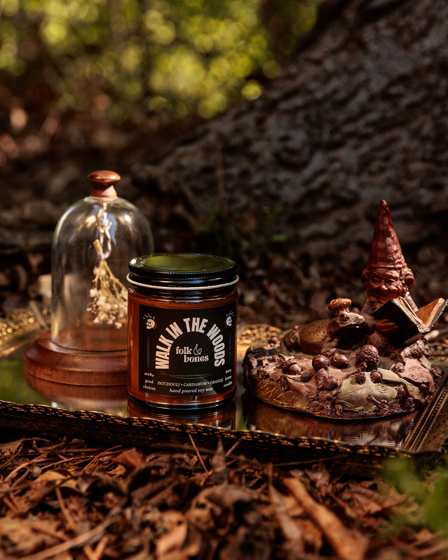 Folk and Bones Walk in the Woods soy candle in an 8 oz jar, featuring a cozy forest-themed label and natural candle wax.