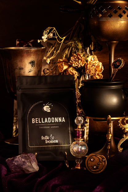 Folk and Bones Belladonna incense cones in a box, showcasing dark purple packaging with candle and fragrance details.