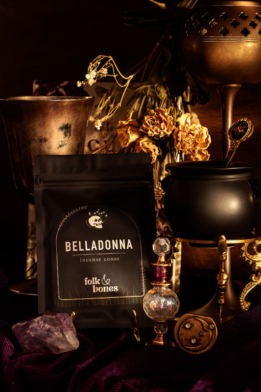 Folk and Bones Belladonna incense cones in a box, showcasing dark purple packaging with candle and fragrance details.
