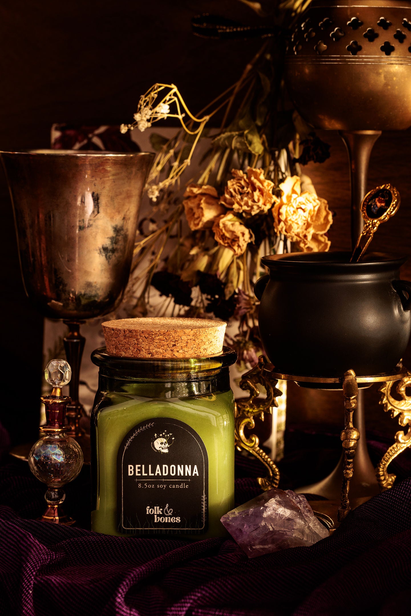 Belladonna soy candle by Folk and Bones, 8 oz candle in a glass jar with a lit wick, showcasing its elegant design and warm glow.