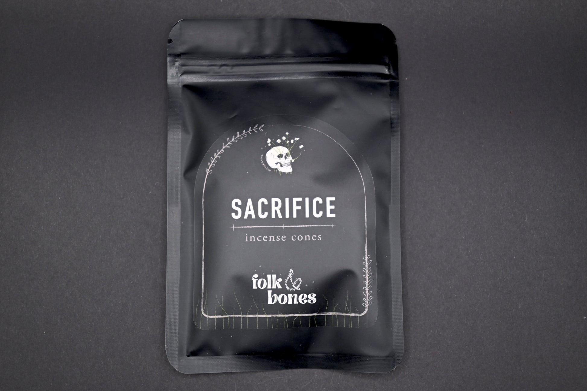 Folk and Bones Sacrifice incense cones set with package of aromatic candles, used for spiritual or decorative purposes.