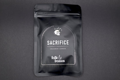 Folk and Bones Sacrifice incense cones set with package of aromatic candles, used for spiritual or decorative purposes.