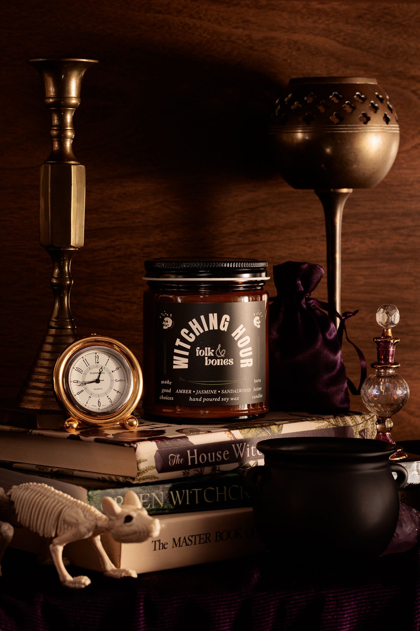 Folk and Bones Witching Hour 8oz soy candle in a glass jar with a black lid, featuring a dark, mystical label design.