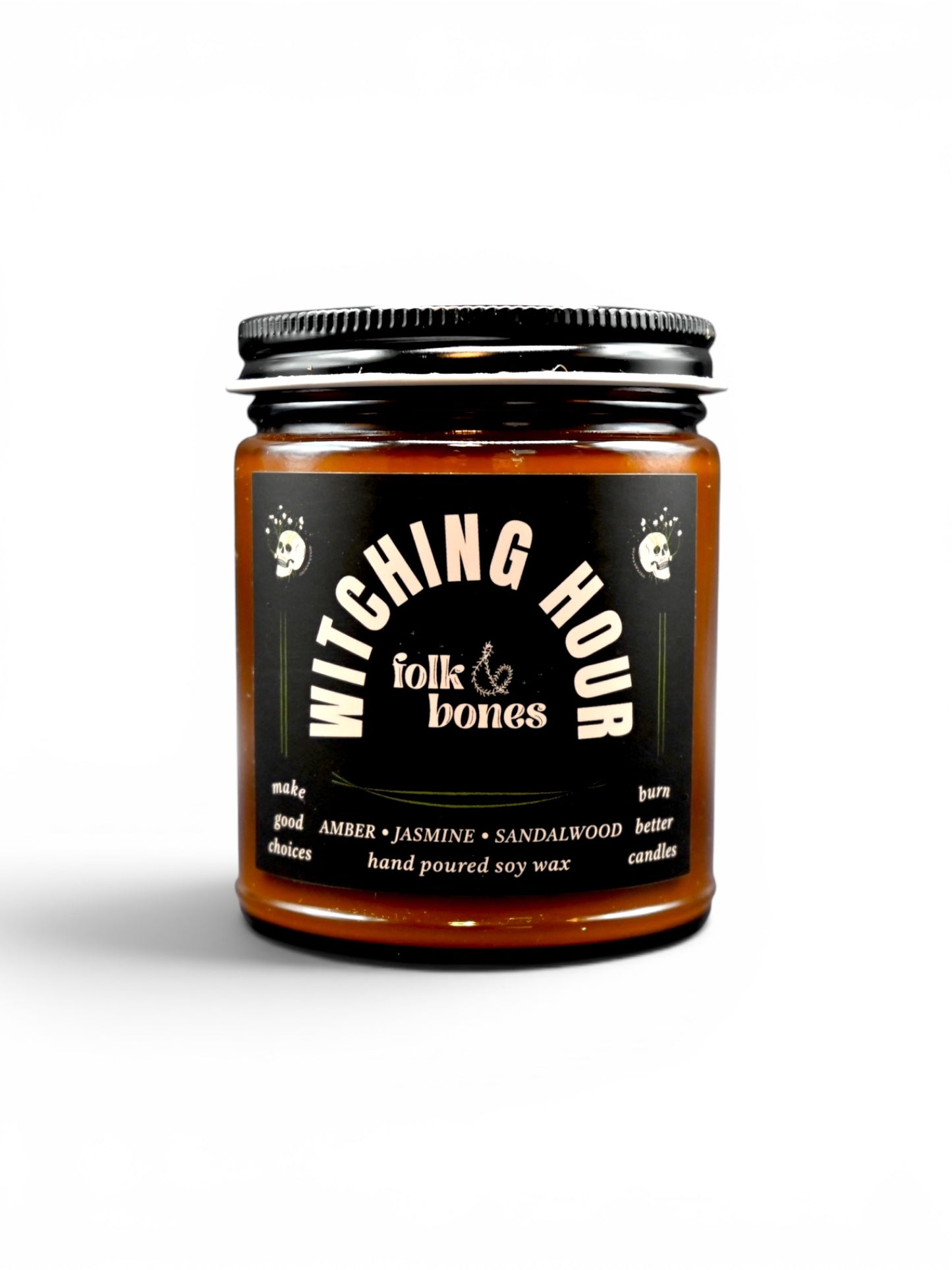 Folk and Bones Witching Hour 8oz soy candle in a dark jar with a black lid, featuring a mystical label and a lit wick.