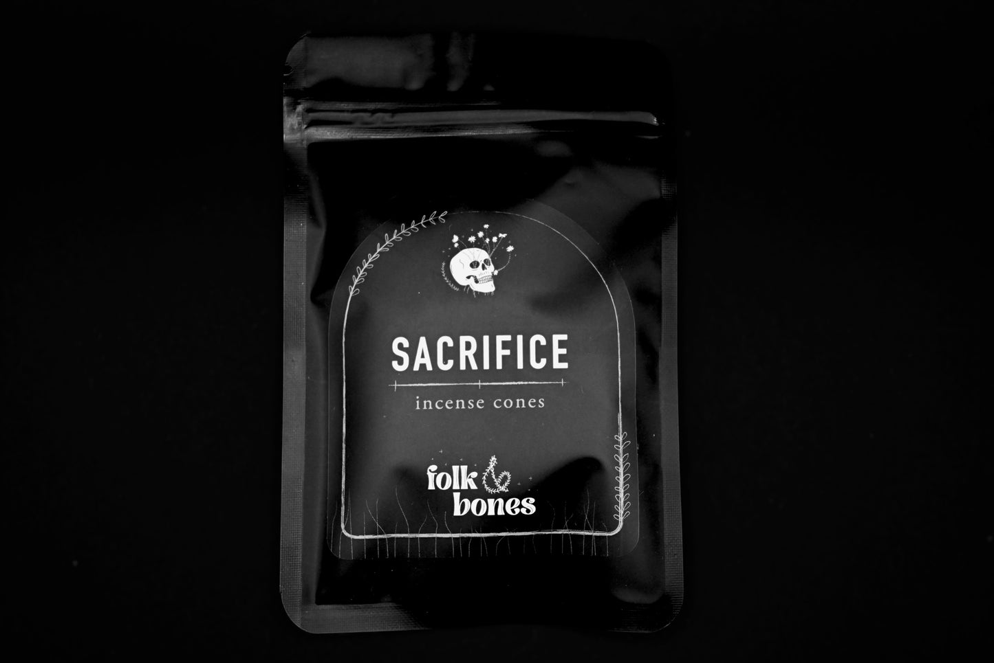 Folk and Bones Sacrifice Incense Cones arranged in a clear container, showcasing aromatic incense for spiritual or meditative use.