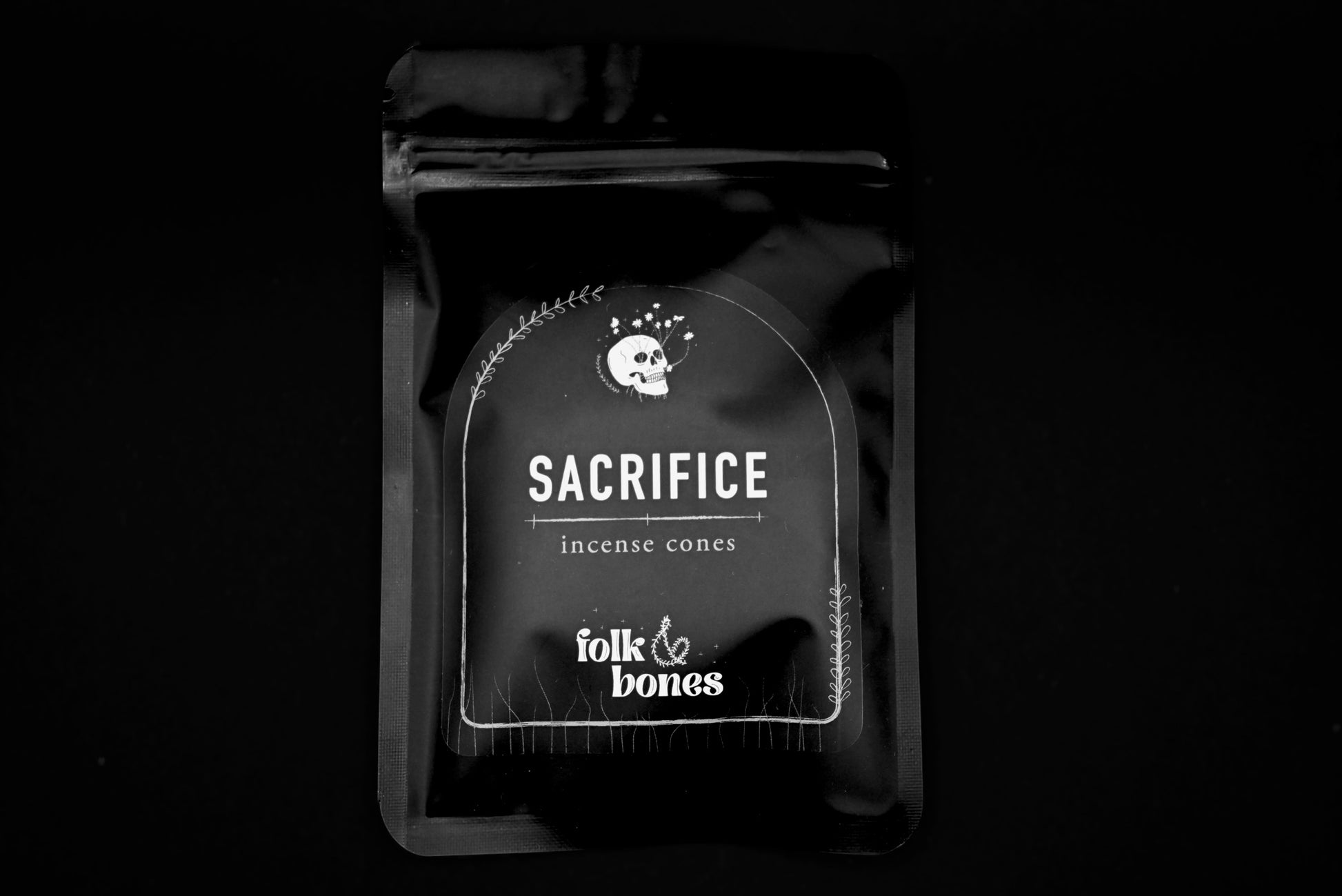 Folk and Bones Sacrifice Incense Cones arranged in a clear container, showcasing aromatic incense for spiritual or meditative use.