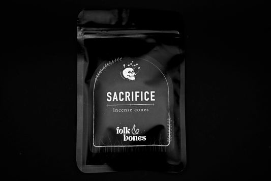 Folk and Bones Sacrifice Incense Cones arranged in a clear container, showcasing aromatic incense for spiritual or meditative use.