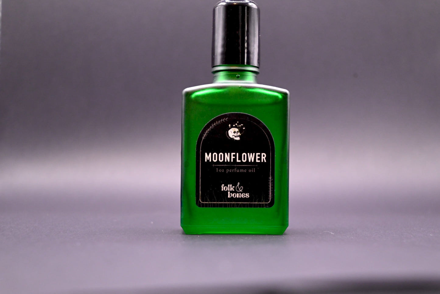 Folk and Bones Moonflower 1 oz perfume oil bottle, featuring a sleek design and label, with a moonflower scent theme.