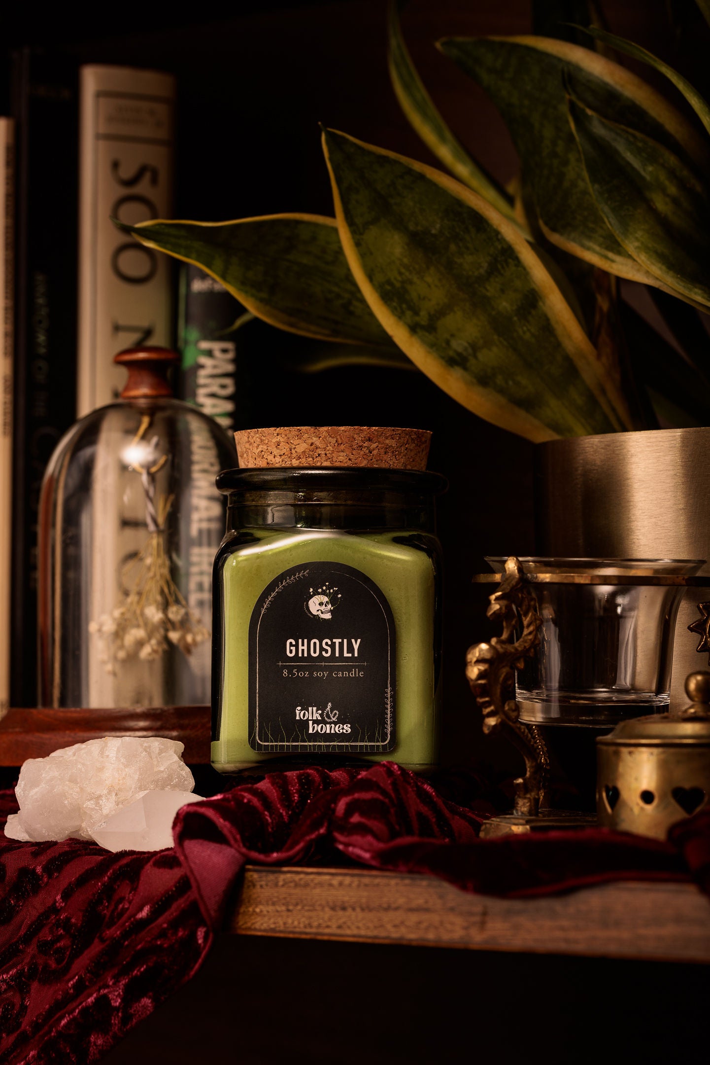 Folk and Bones Ghostly 8 oz soy candle in a glass jar with a white label, featuring a ghostly design and a lit wick.