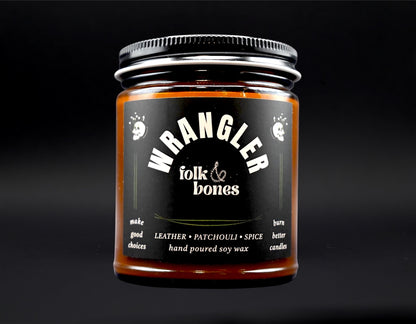 Wrangler 8 oz soy candle by Folk and Bones, showcasing a white jar with a wooden wick and minimalist label design.