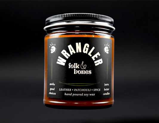 Wrangler 8 oz soy candle by Folk and Bones, showcasing a white jar with a wooden wick and minimalist label design.