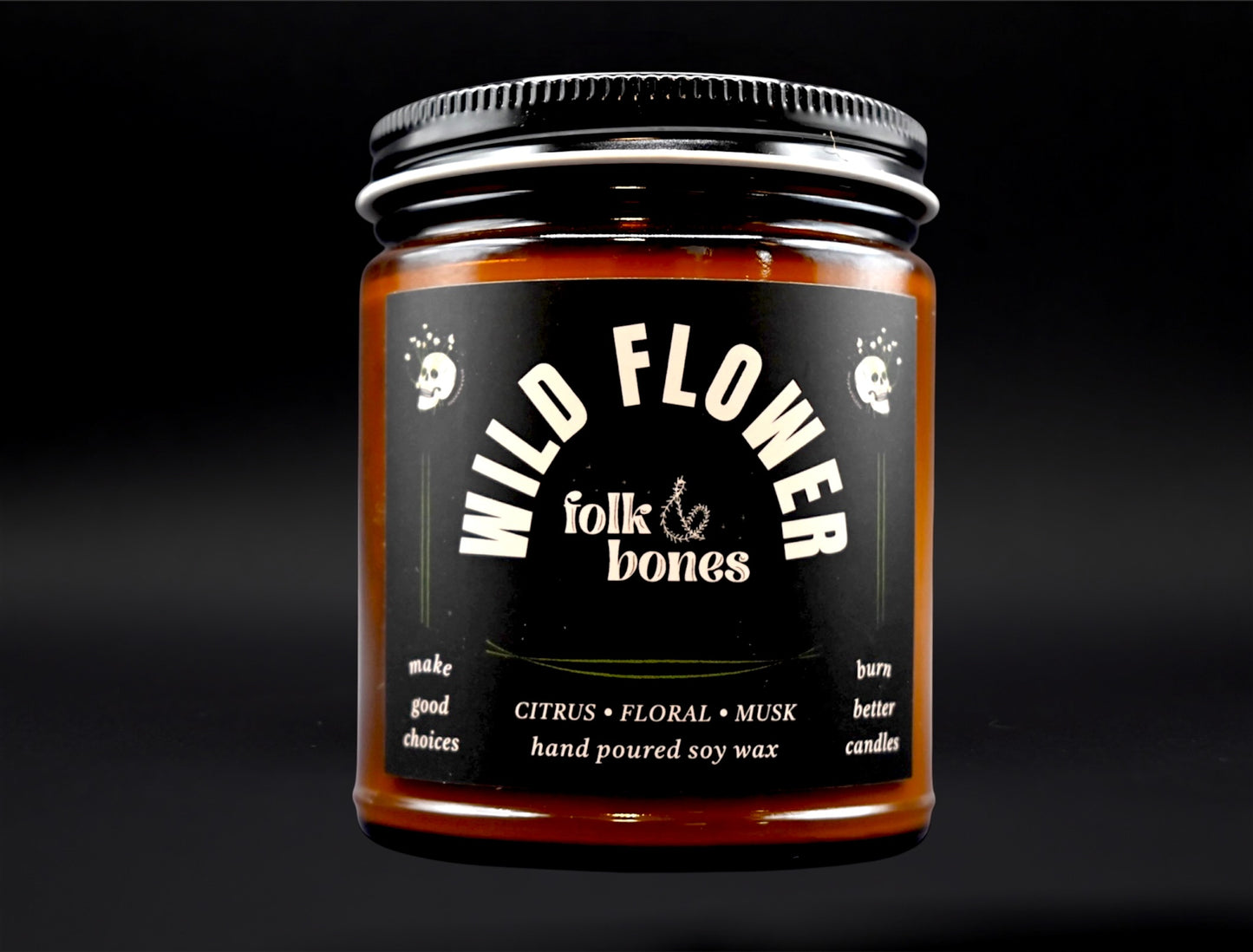 Folk and Bones Wild Flower 8 oz soy candle with a rustic glass jar and a natural floral label, perfect for home décor and ambiance.