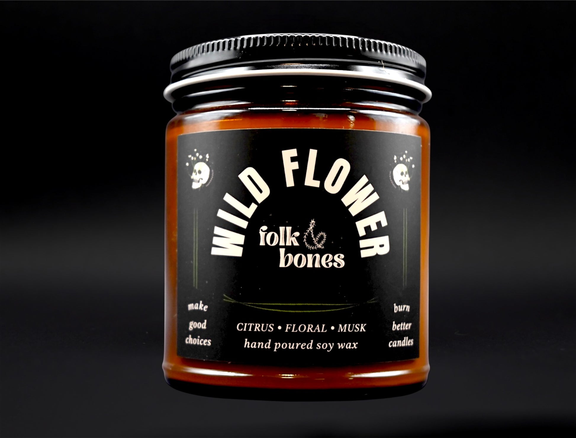Folk and Bones Wild Flower 8 oz soy candle with a rustic glass jar and a natural floral label, perfect for home décor and ambiance.