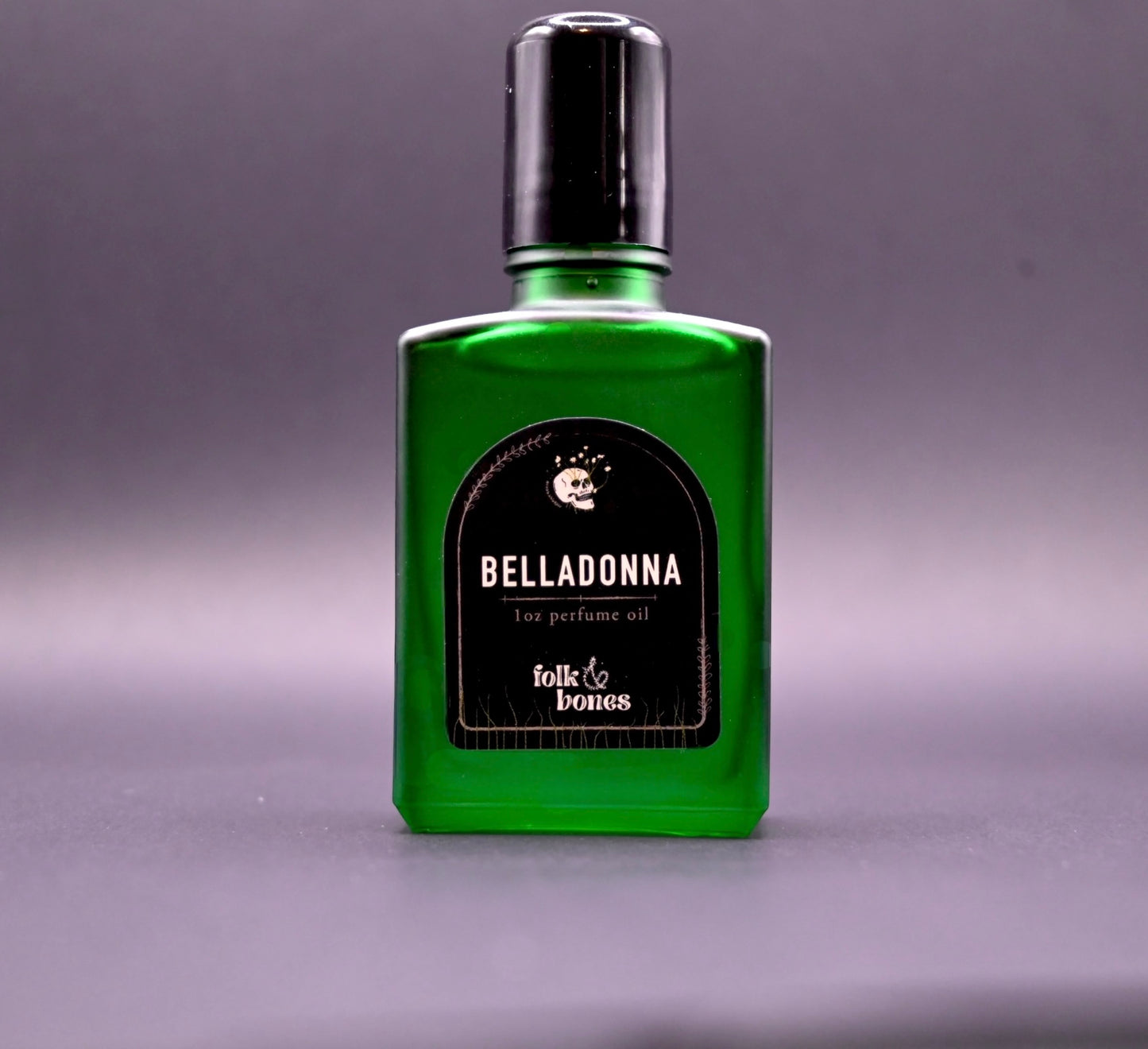 Folk and Bones Belladonna 1 oz perfume oil candle with dark wax and elegant label, ready for aromatic use.