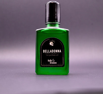 Folk and Bones Belladonna 1 oz perfume oil candle with dark wax and elegant label, ready for aromatic use.