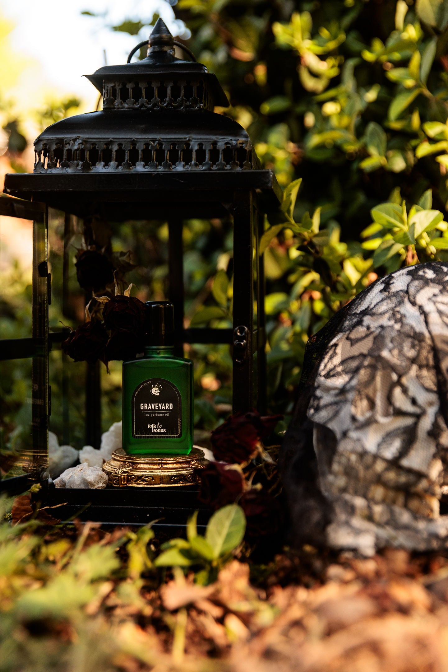 Folk and Bones Graveyard 1 oz perfume oil candle with dark wax and intricate label design.