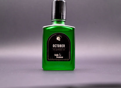 Folk and Bones October 1 oz perfume oil candle with a sleek, dark glass container and minimalist label.