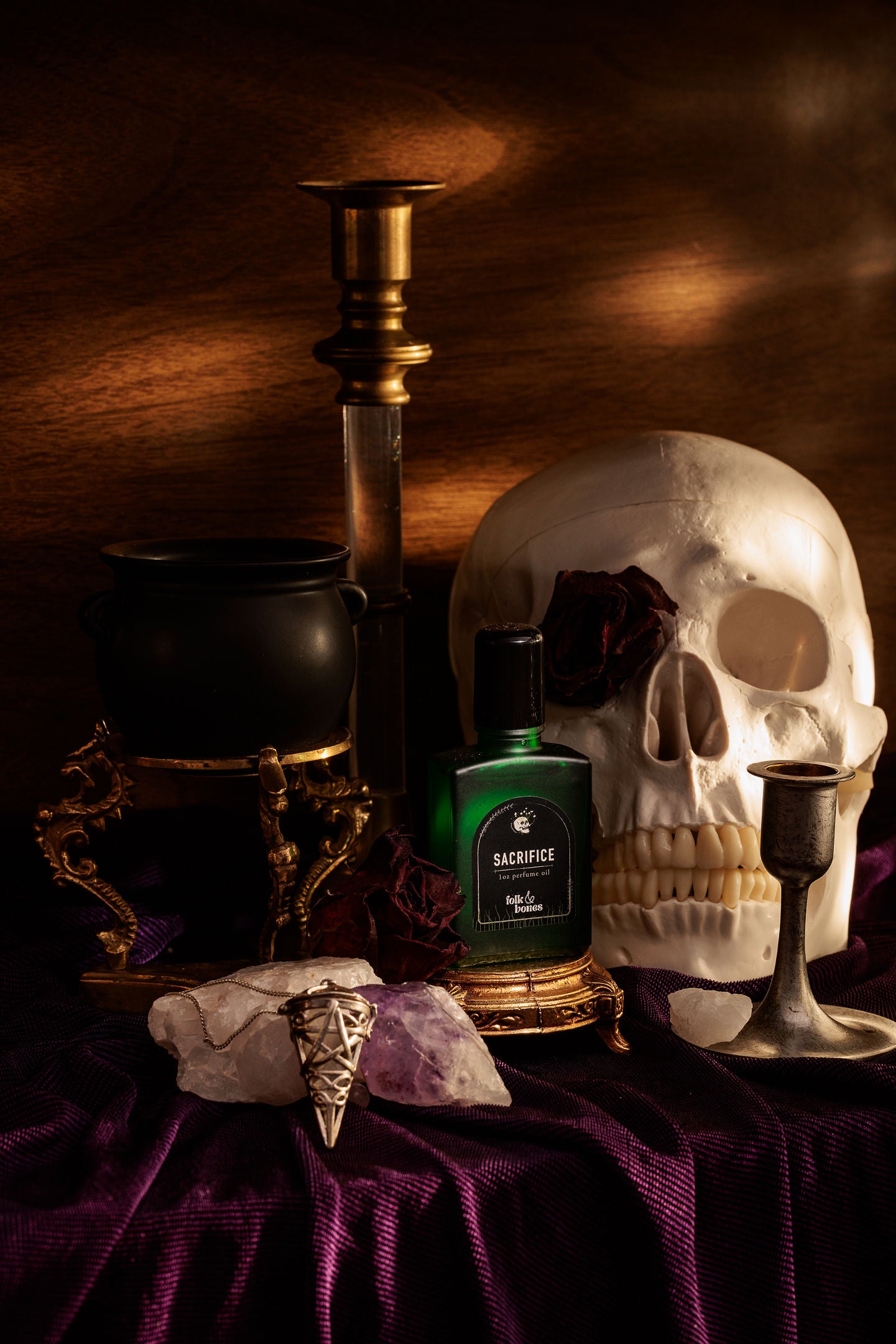 Folk and Bones Sacrifice 1 oz perfume oil candle with a sleek black container and minimalist label design.