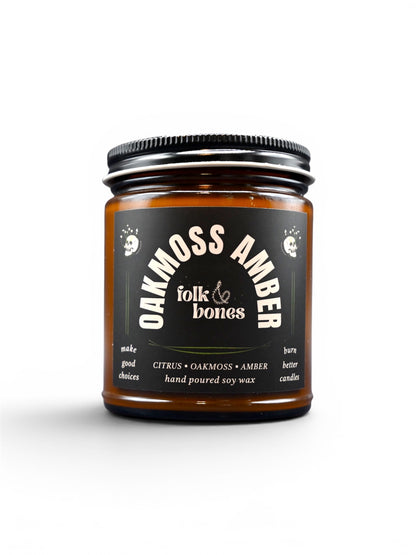 Folk and Bones Oakmoss Amber soy candle in 8 oz glass jar, featuring a warm, earthy scent with amber and moss notes.